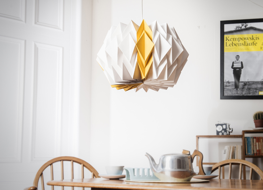 Kate Colin Large Starflower Shade in mustard yellow hanging over dining table