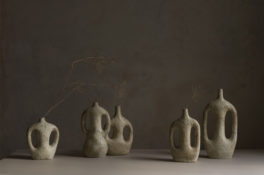 ceramics vessels in neutral tones against plain background