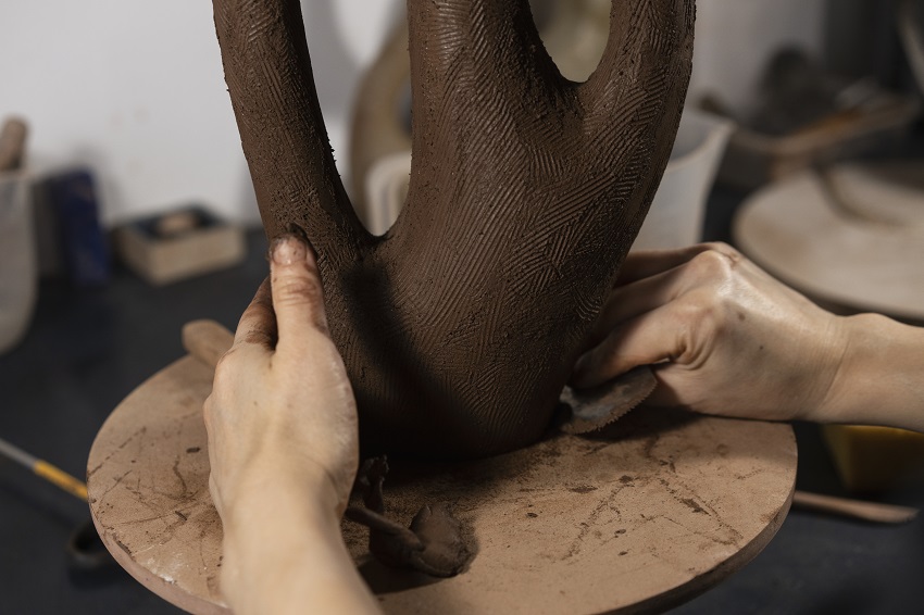 hands making clay pot