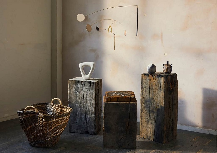 Craft objects on plinths against wall