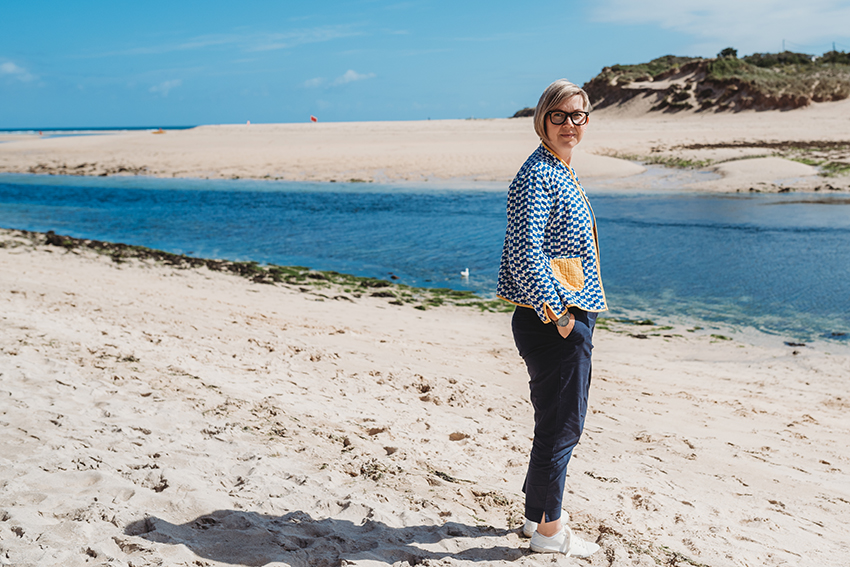 Katie Treggiden stands on a beach