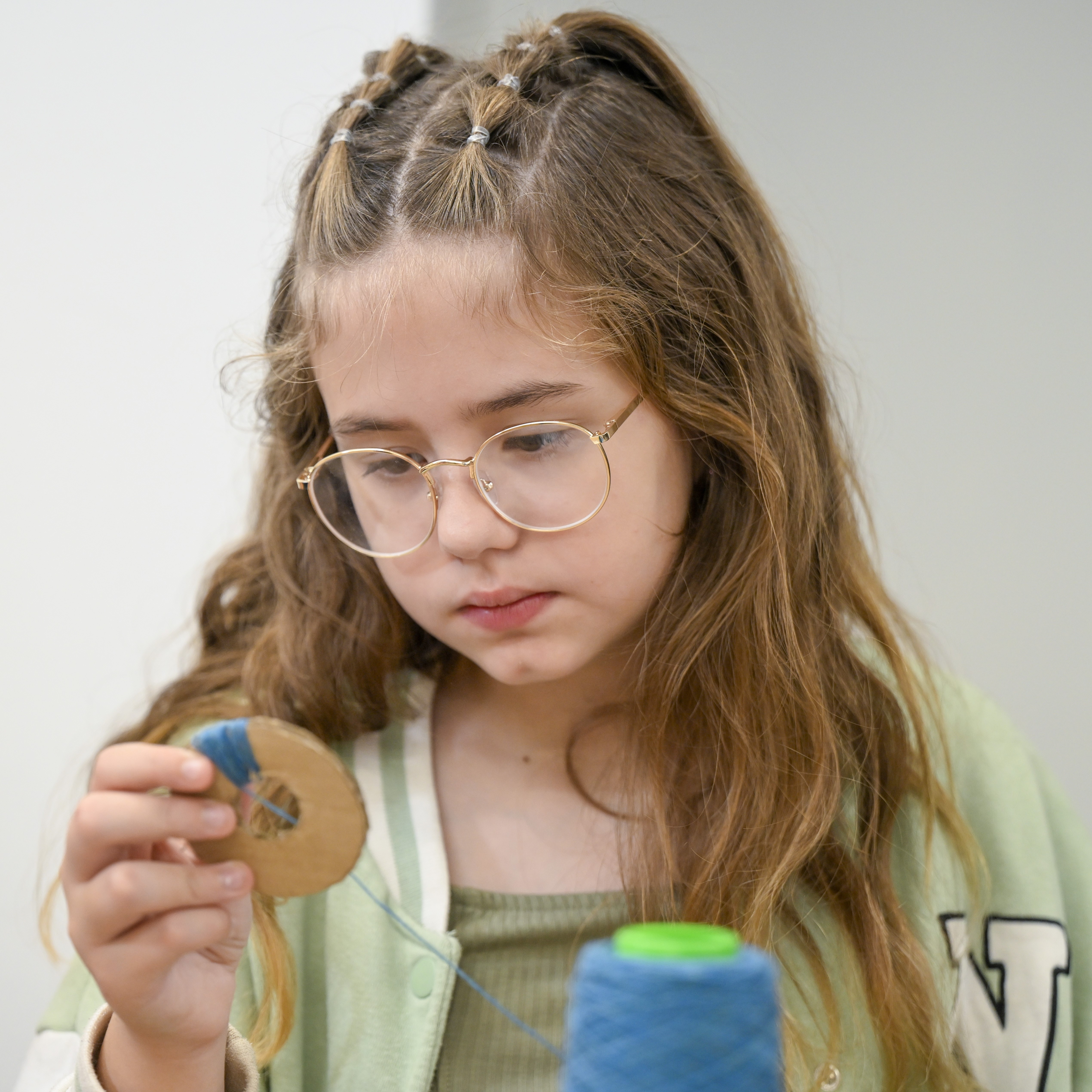 child making a pompom